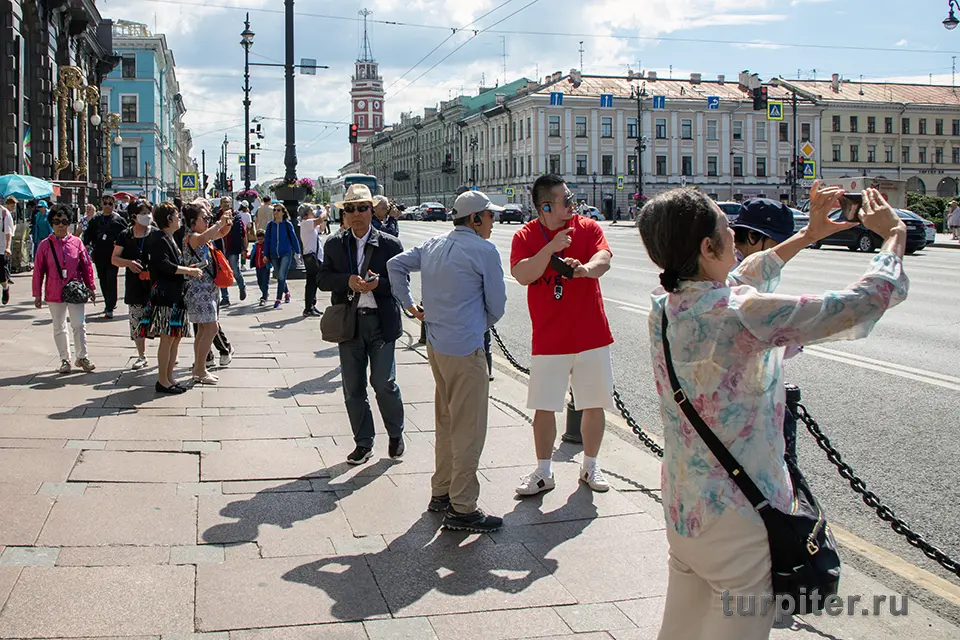 китайские туристы на Невском проспекте Петербурга